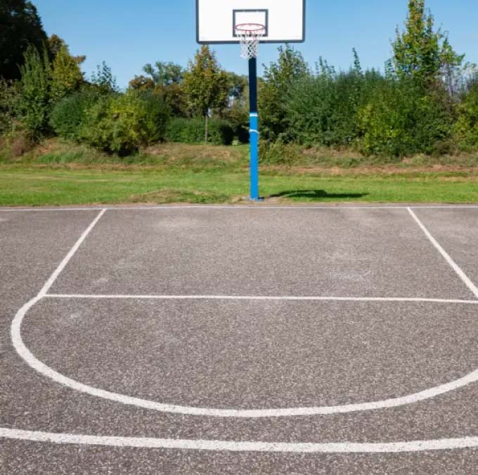 Outdoor basketball court with hoop and painted free-throw line