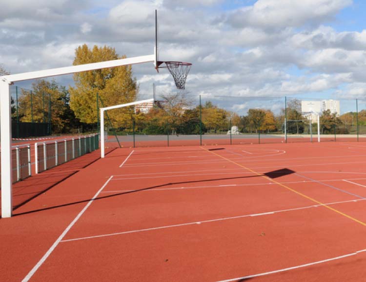 Outdoor multi-sport court with basketball hoops and painted court lines